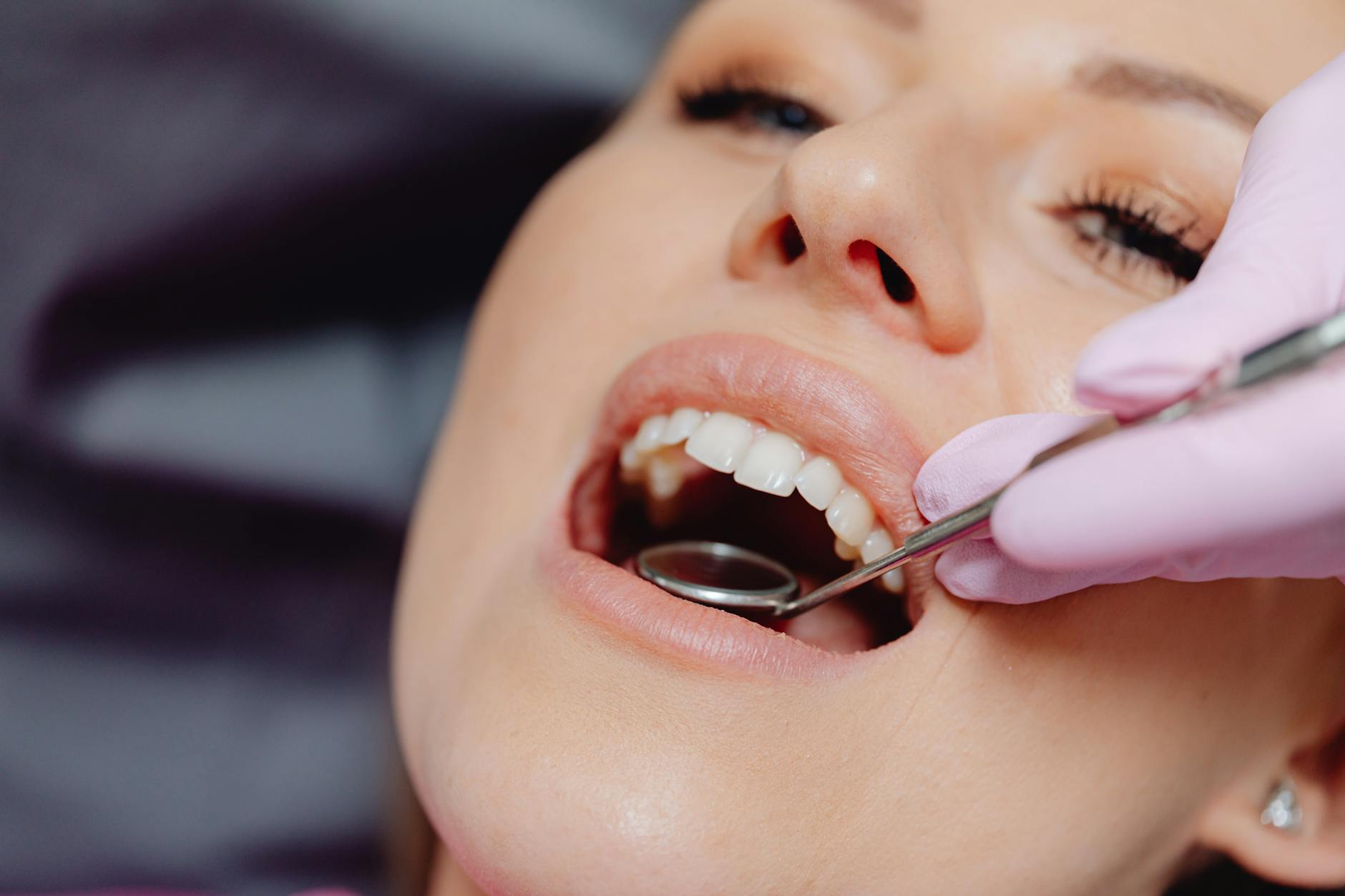 a mouth mirror in a patient s mouth